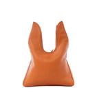 Hermès Massai PM shoulder bag in orange pebbled leather with curved cutout handle silhouette on white background.
