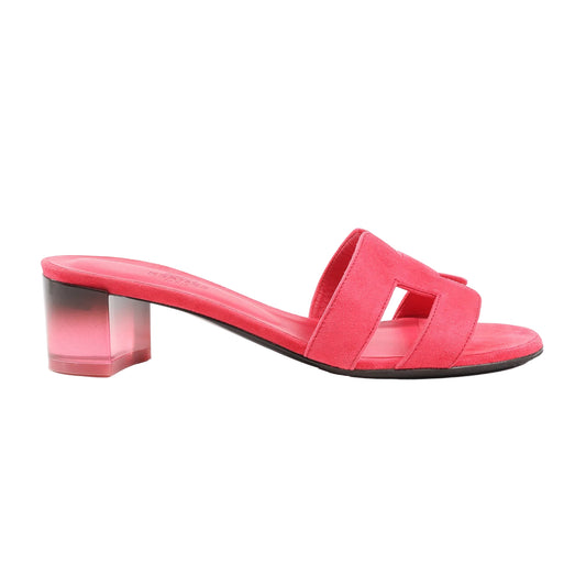 Hermès Oasis sandals in vibrant pink suede featuring the iconic “H” cut-out upper design, open toe, and translucent pink block heel. Side view, size 38 EU.