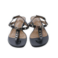 Black Hermès Olivia leather sandals with T-bar straps, silver-tone pyramid studs, turn-lock hardware and adjustable ankle buckles.