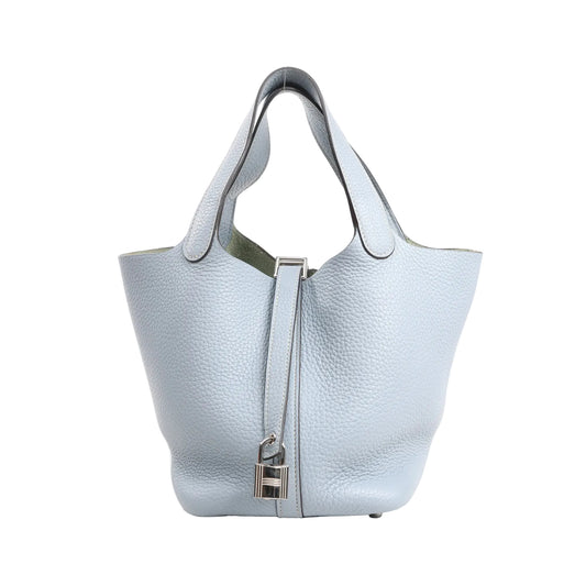 Hermes Picotin Lock 18 PM handbag in soft blue Taurillon Clemence leather, featuring a bucket-style silhouette, top handles, and silver-tone padlock closure.