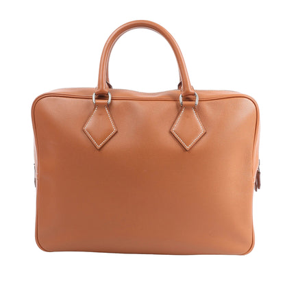 HERMÈS Plume 40 handbag in gold Evercolor leather with double top handles, white contrast stitching, and silver-tone hardware, shown upright against a white background.