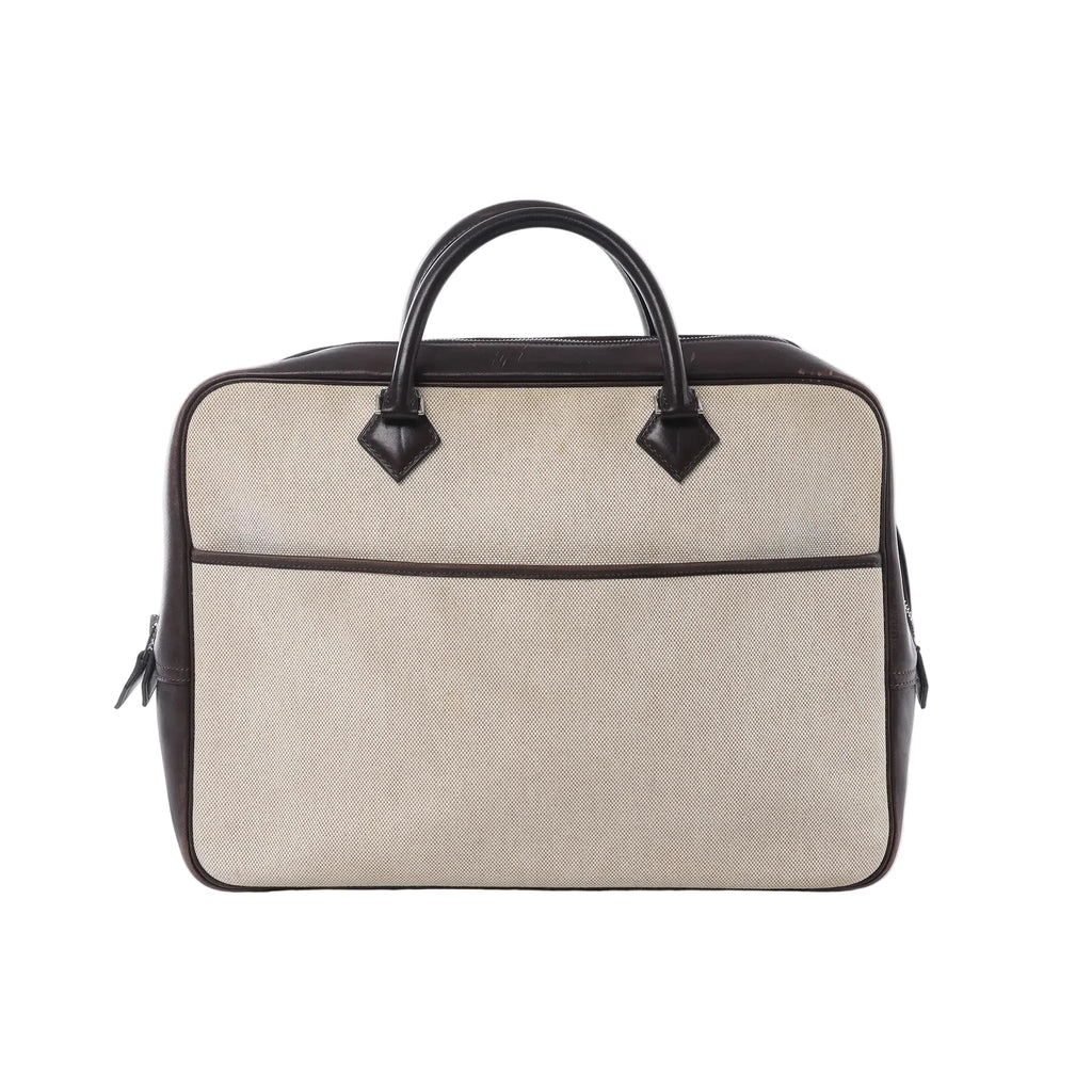 Hermès Plume Dog 38 bag in beige Toile H canvas with dark brown leather trim and top handles, zip-top design on white background.