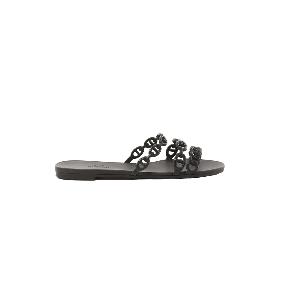 Black Hermès Rivage rubber slide sandal with chain-link style straps on a white background.