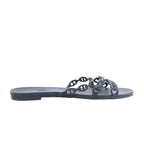 Hermès Rivage black rubber slide sandal with chain-link straps and flat sole on a white background.