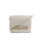 Hermès Sac Roulis 23 crossbody bag in pearl gray leather with front flap, gold-tone Roulis clasp detail, and matching shoulder strap on a white background.