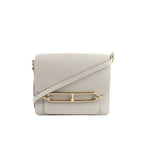 Hermès Sac Roulis 23 crossbody bag in pearl gray leather with front flap, gold-tone Roulis clasp detail, and matching shoulder strap on a white background.