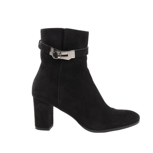 Hermès Saint Germain Kelly ankle boots in black suede featuring a rounded toe, mid-height block heel, and silver-tone Kelly-style buckle strap detail around the ankle. Size 37 EU.