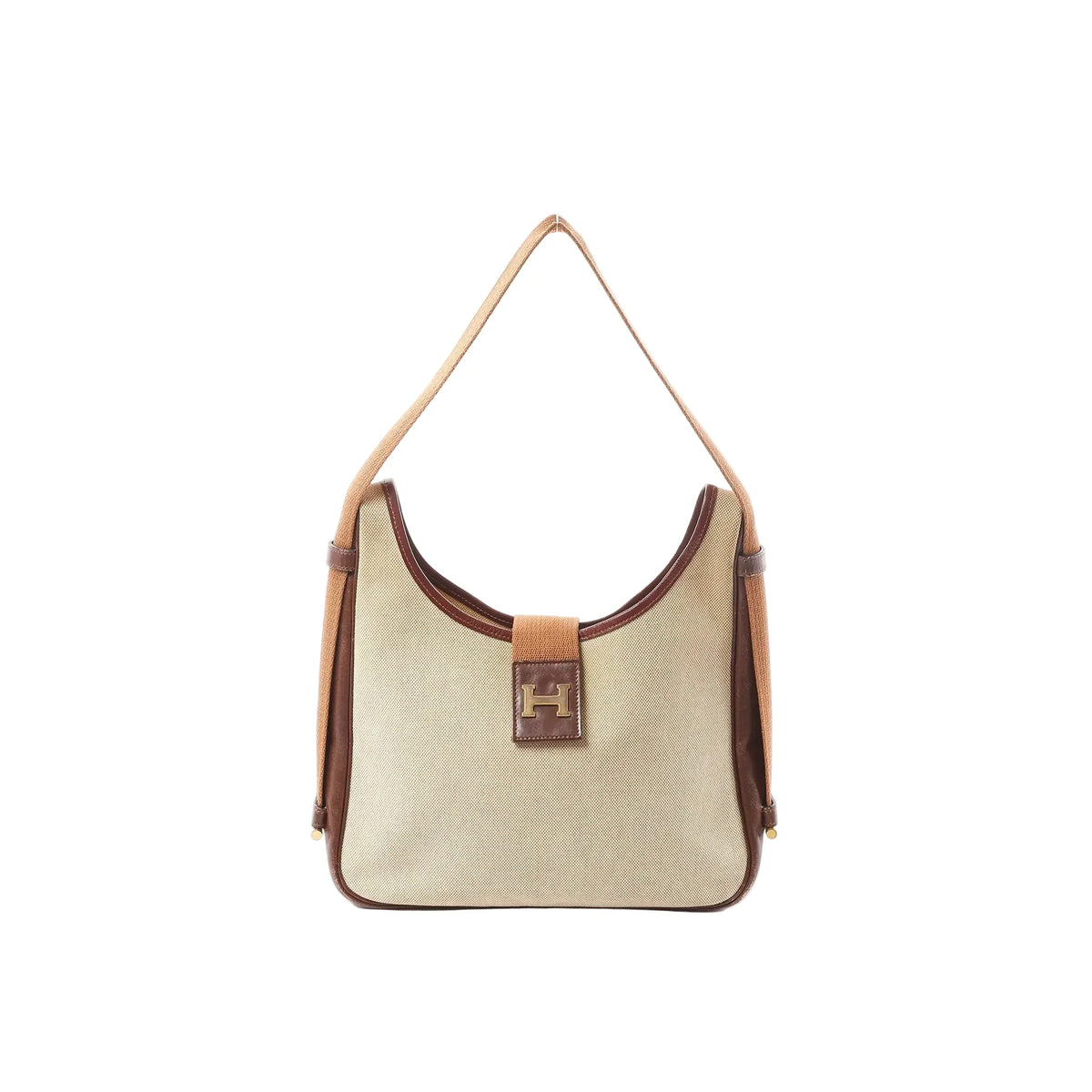 Front view of Hermès Sako shoulder bag in beige Toile H canvas with brown leather trim, long tan strap, and front leather tab with gold-tone H detail.