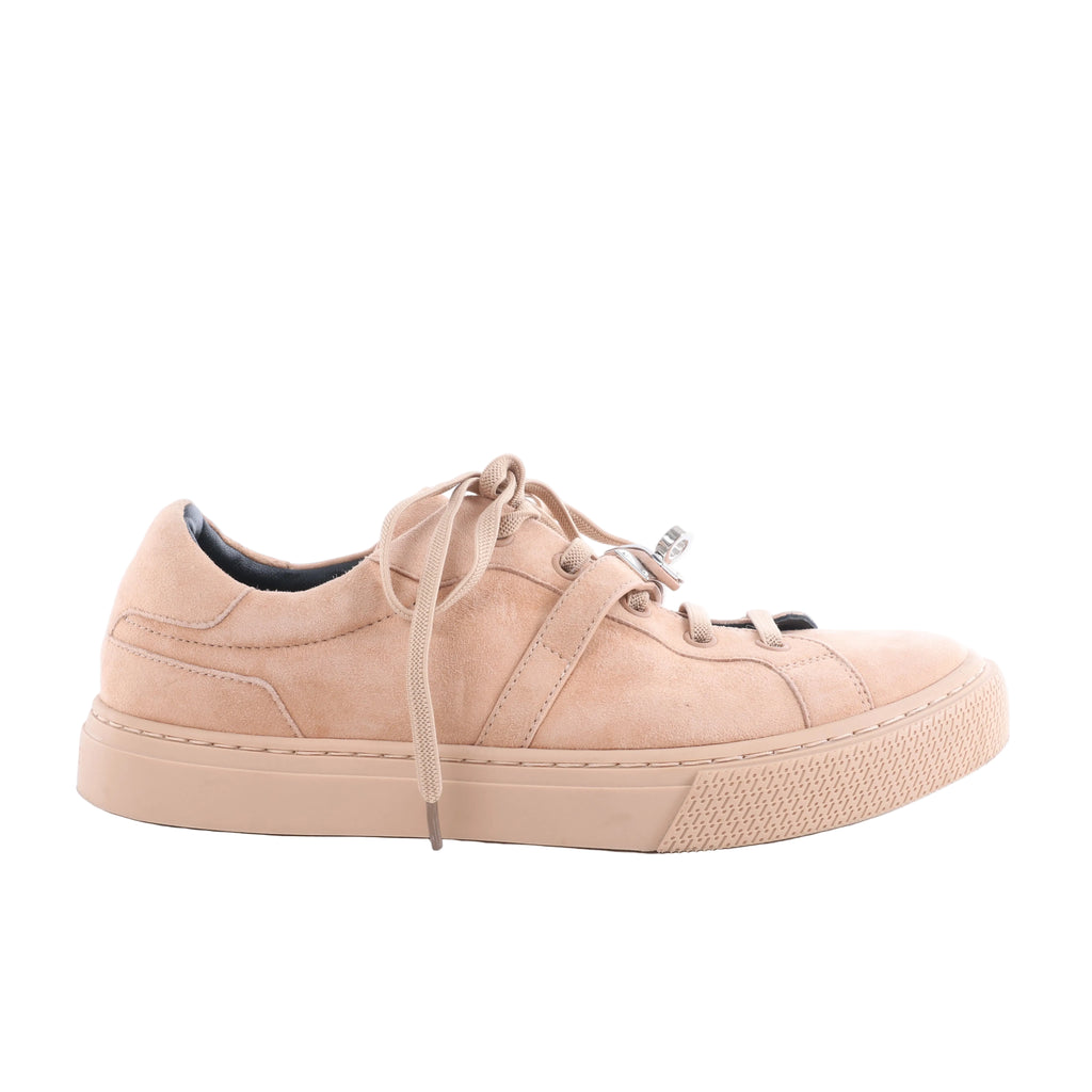 Hermès Day beige suede low-top sneaker with tonal laces, matching rubber sole and silver-tone buckle hardware.