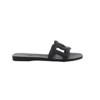 Black Hermès Aloha rubber slide sandal with sculpted cutout upper, flat sole and open-toe silhouette.