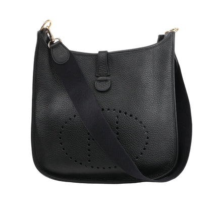 Hermès Evelyne 1 33 GM shoulder bag in black Taurillon Clemence leather featuring perforated H logo, black canvas strap, and gold-tone hardware.