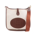 Beige Hermès Evelyne 1 33 GM canvas shoulder bag with brown leather trim, large perforated H oval, wide rust-brown strap and gold-tone hardware.