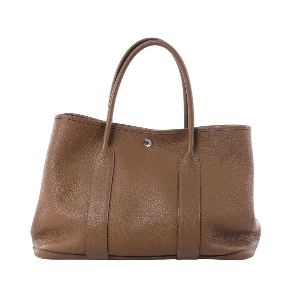 Hermès Garden Party 36 PM brown textured leather tote with twin top handles, vertical leather bands and silver-tone snap closure.