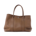 Hermès Garden Party 36 PM brown textured leather tote with twin top handles, vertical leather bands and silver-tone snap closure.