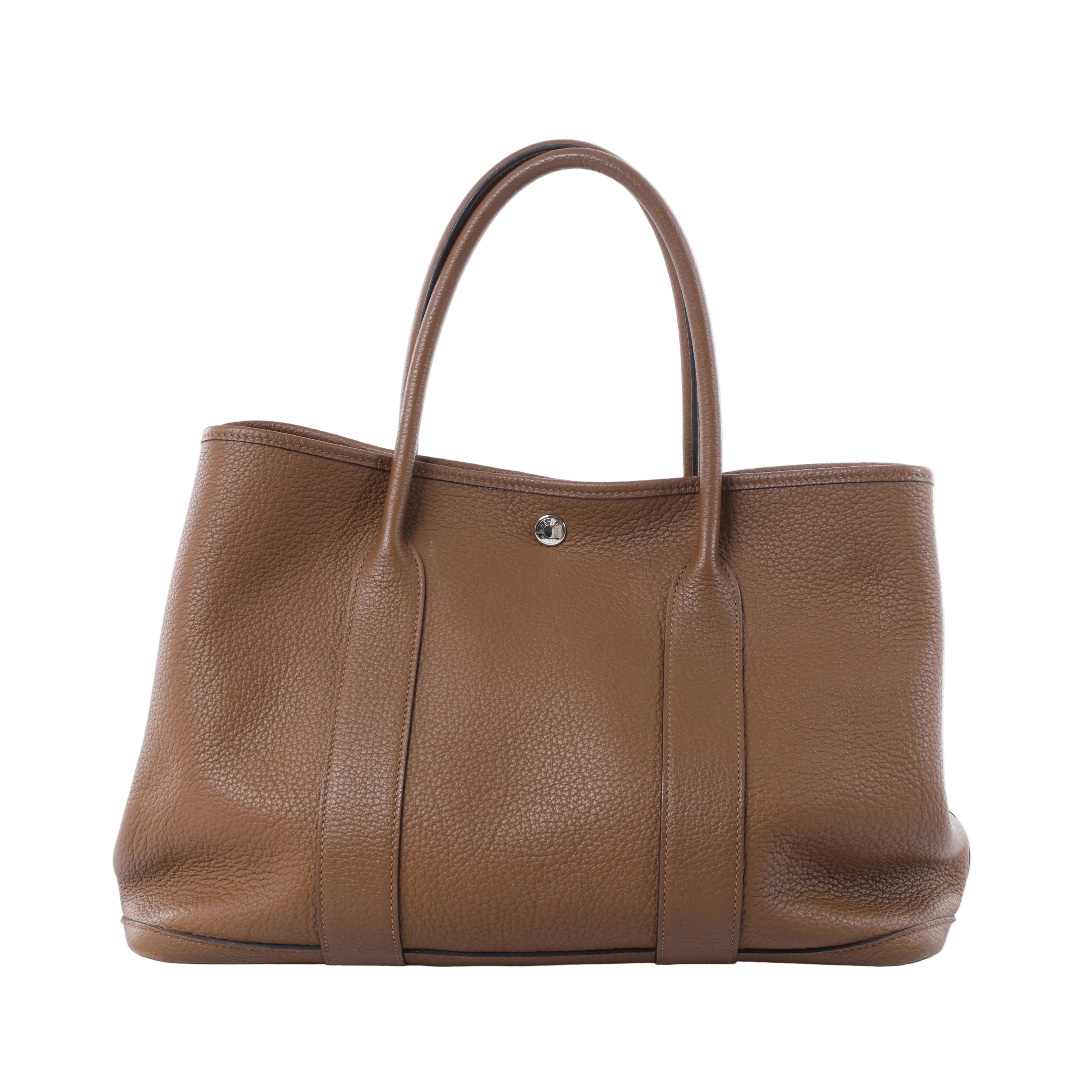 Hermès Garden Party 36 PM brown textured leather tote with twin top handles, vertical leather bands and silver-tone snap closure.