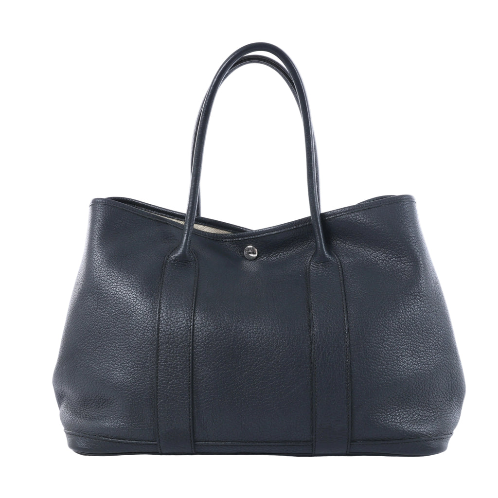 Hermès Garden Party 36 PM black textured leather tote with long top handles, vertical leather bands and silver-tone snap closure.