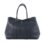 Hermès Garden Party 36 PM black textured leather tote with long top handles, vertical leather bands and silver-tone snap closure.
