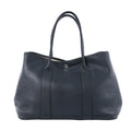 Hermès Garden Party 36 PM black textured leather tote with long top handles, vertical leather bands and silver-tone snap closure.