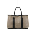 Beige Hermès Garden Party 36 PM canvas tote with dark brown leather handles and trim, vertical leather panels and silver-tone snap closure.