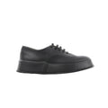 Black Jil Sander leather lace-up sneaker with smooth upper, tonal laces, and thick platform-style rubber sole, shown in side profile.