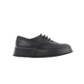 Black Jil Sander leather lace-up sneaker with smooth upper, tonal laces, and thick platform-style rubber sole, shown in side profile.