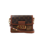 Louis Vuitton Dauphine Mini crossbody bag with Monogram and Monogram Reverse canvas, leather trim, shoulder strap and gold-tone LV clasp.