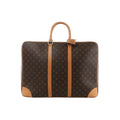 Brown Louis Vuitton Sirius 55 Monogram canvas travel bag with natural leather handles, vertical trim and reinforced leather corners.