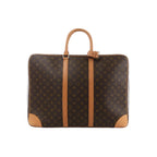 Brown Louis Vuitton Sirius 55 Monogram canvas travel bag with natural leather handles, vertical trim and reinforced leather corners.