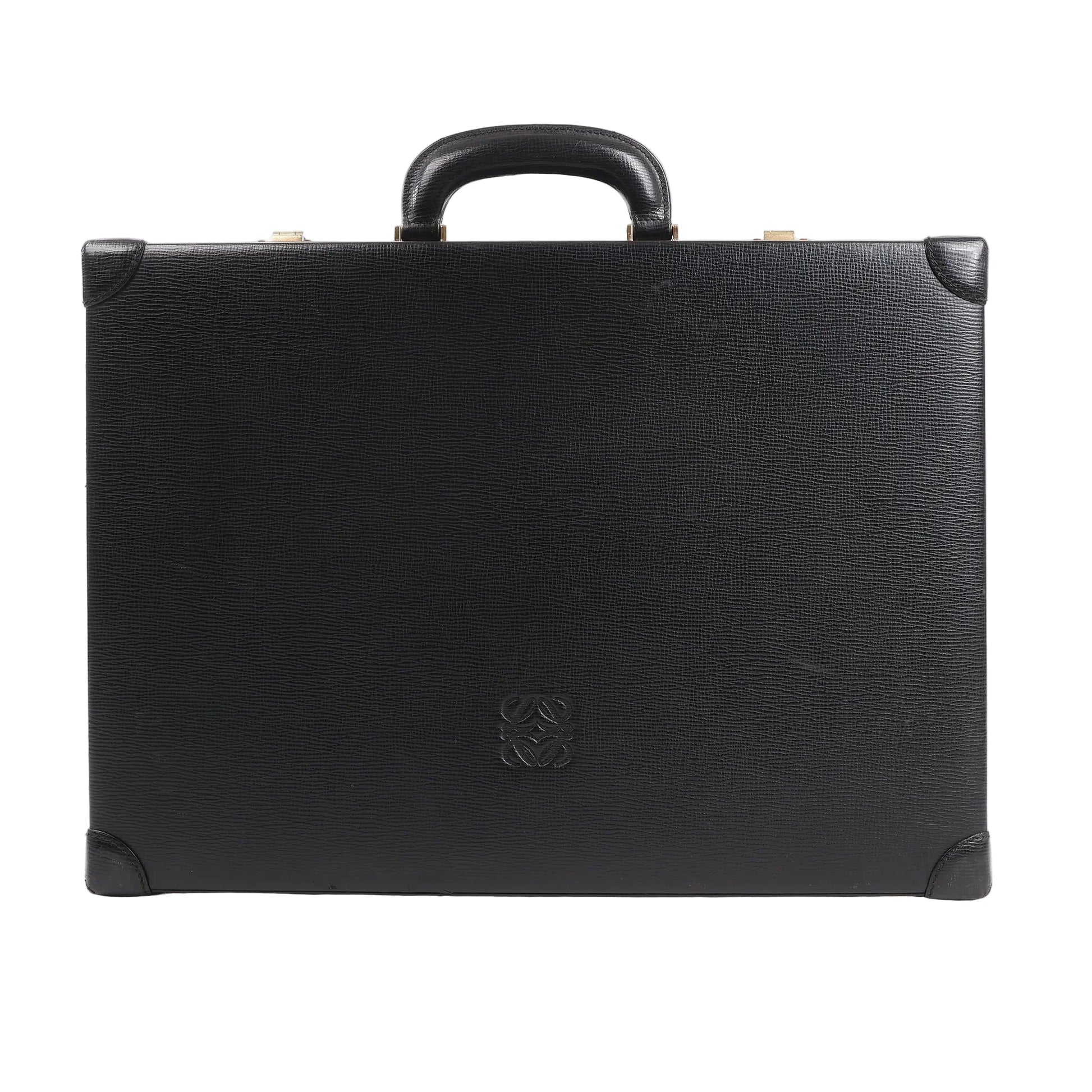 Loewe Anagram travel bag in black textured leather featuring a structured rectangular silhouette, top handle, reinforced leather corners, and embossed Anagram logo at the center, displayed against a white background.