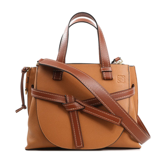 LOEWE Gate Top Handle handbag in brown pebbled leather featuring a structured silhouette, knotted front belt detail, white contrast stitching, dual top handles, and a detachable shoulder strap for 2-way wear.