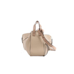 Beige grained leather LOEWE Hammock Medium handbag with top handles, detachable shoulder strap, gold-tone hardware, and side zip detail.
