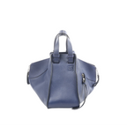 Navy blue leather LOEWE Hammock Medium handbag with top handles, detachable shoulder strap, side zip detail, and embossed logo on the front.