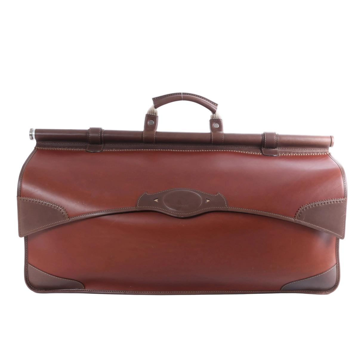 Brown Loewe leather travel bag with elongated structured body, darker brown trim, top handle and metal hardware on a white background.