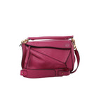 LOEWE Puzzle Small handbag in pink leather with geometric panels, a rolled top handle, adjustable shoulder strap and gold-tone hardware.