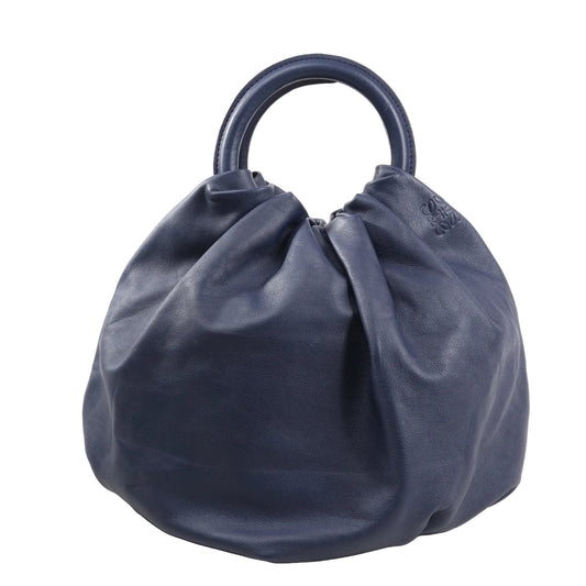 Front view of the LOEWE Bounces handbag in navy blue leather, featuring a soft, slouchy silhouette with structured round top handles and subtle embossed logo detail.