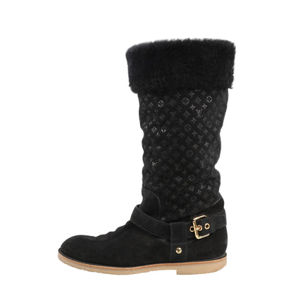 Louis Vuitton 12 Years boots in black suede featuring Monogram-embossed shaft, shearling cuff, gold-tone buckle detail, and flat rubber sole.