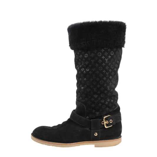 Louis Vuitton 12 Years boots in black suede featuring Monogram-embossed shaft, shearling cuff, gold-tone buckle detail, and flat rubber sole.