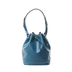 Blue Louis Vuitton Noé bucket bag in Epi leather with drawstring top, gold-tone grommets, and adjustable shoulder strap on a white background.