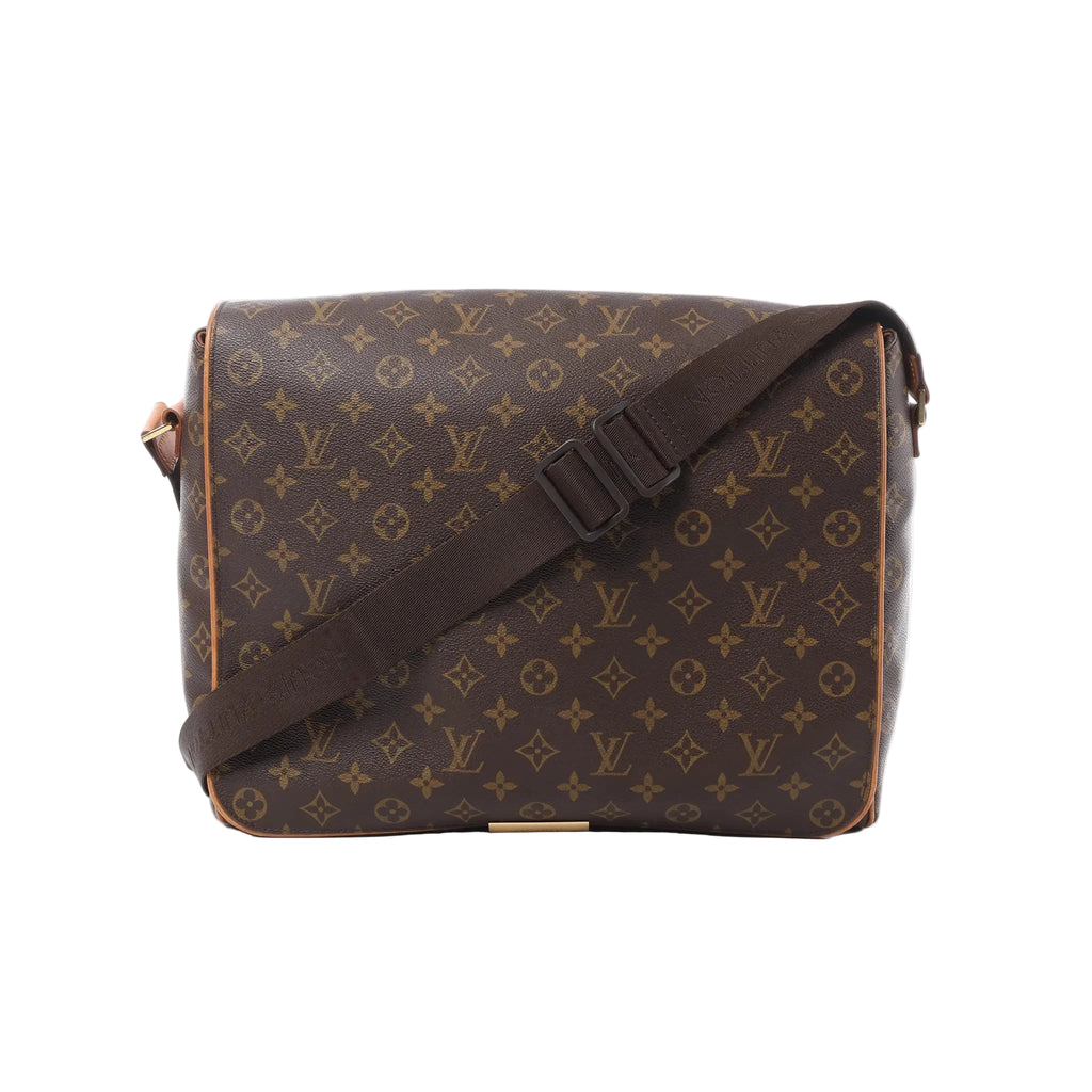 Louis Vuitton Monogram canvas Abbesses messenger bag with wide adjustable brown shoulder strap and vachetta trim on white background.