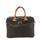 Louis Vuitton Agal handbag in brown Monogram canvas with tan vachetta leather top handles, gold-tone zip hardware, and front zip compartment on white background.