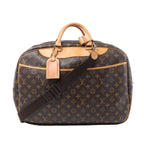 Front view of a brown Louis Vuitton Alize 2 Poches Monogram canvas travel bag with tan leather handles, trim, luggage tag and dark brown shoulder strap.