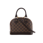 Brown Louis Vuitton Alma BB handbag in Damier Ebene checkered canvas with dark leather handles, detachable shoulder strap and gold-tone hardware.