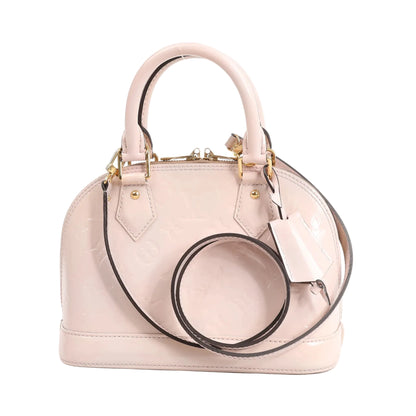 Louis Vuitton Alma BB 2Way handbag in glossy pink Monogram Vernis patent leather with gold-tone hardware, dual top handles, and long shoulder strap.