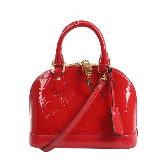 Louis Vuitton Alma BB M90174 handbag in shiny red Monogram Vernis leather with structured shape, gold-tone hardware, top handles, and detachable crossbody strap.