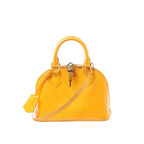 Yellow Louis Vuitton Alma BB Monogram Vernis patent leather handbag with embossed monogram, top handles, detachable shoulder strap, and padlock at the top zip.