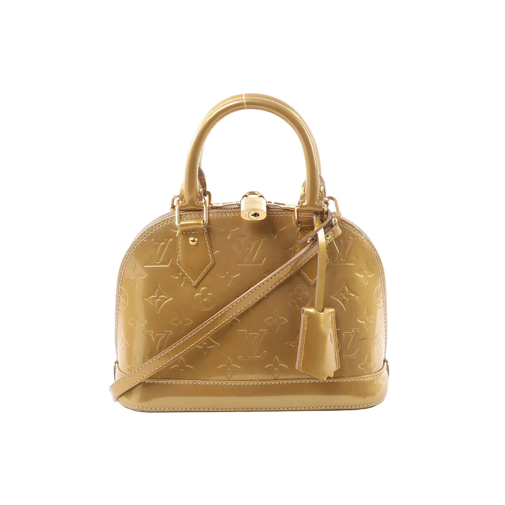 Gold Louis Vuitton Alma BB Monogram Vernis patent handbag with embossed monogram, top handles, detachable shoulder strap, and clochette detail.