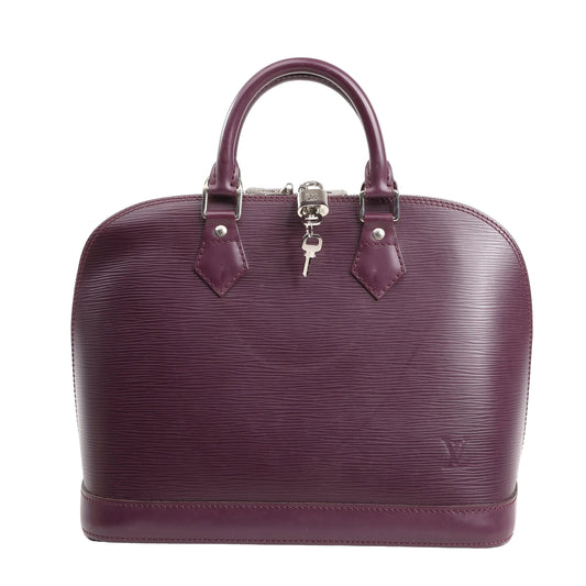 Louis Vuitton Alma handbag in deep purple Epi leather featuring a structured dome shape, dual rolled handles, silver-tone hardware, and a lock with keys attached to the zipper.
