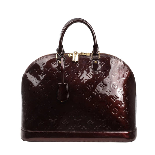 Louis Vuitton Vernis Alma GM handbag in burgundy patent leather featuring embossed monogram pattern, structured dome shape, dual top handles, gold-tone padlock, and zipper closure.