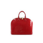 Louis Vuitton Alma GM handbag in glossy red Vernis patent leather with embossed Monogram, top handles, zip-top closure, and gold-tone padlock on a white background.