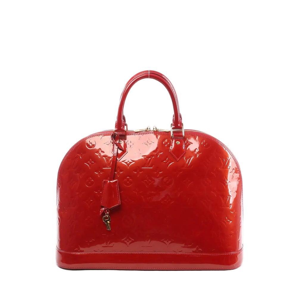 Louis Vuitton Alma GM handbag in glossy red Vernis leather with embossed Monogram, double top handles, zip-top closure, and leather clochette with keys, front view on white background.